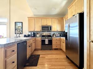 Full kitchen with granite counters and stainless steel appliances